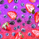Various berries on a fizzy pink and purple background